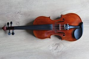 brown violin on white textile