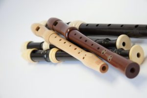 brown wooden flute on white table